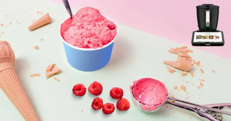 Boules de sorbet framboise maison onctueux réalisé au Thermomix, servies dans une coupe avec des framboises fraîches et de la menthe.